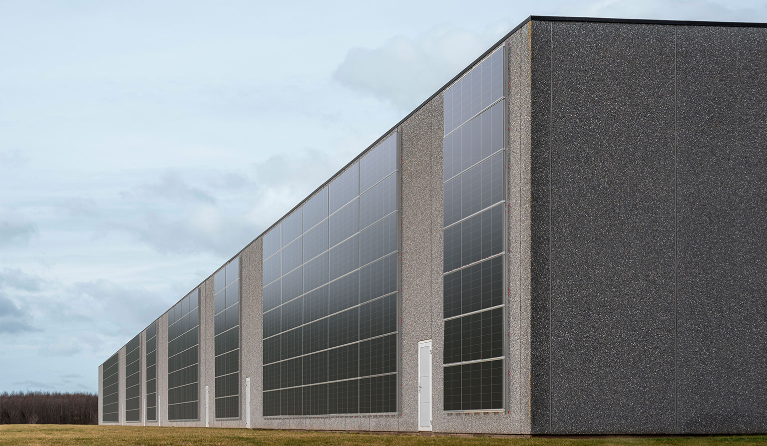 PV system with FacadeRail mounting system as curtain wall on concrete wall